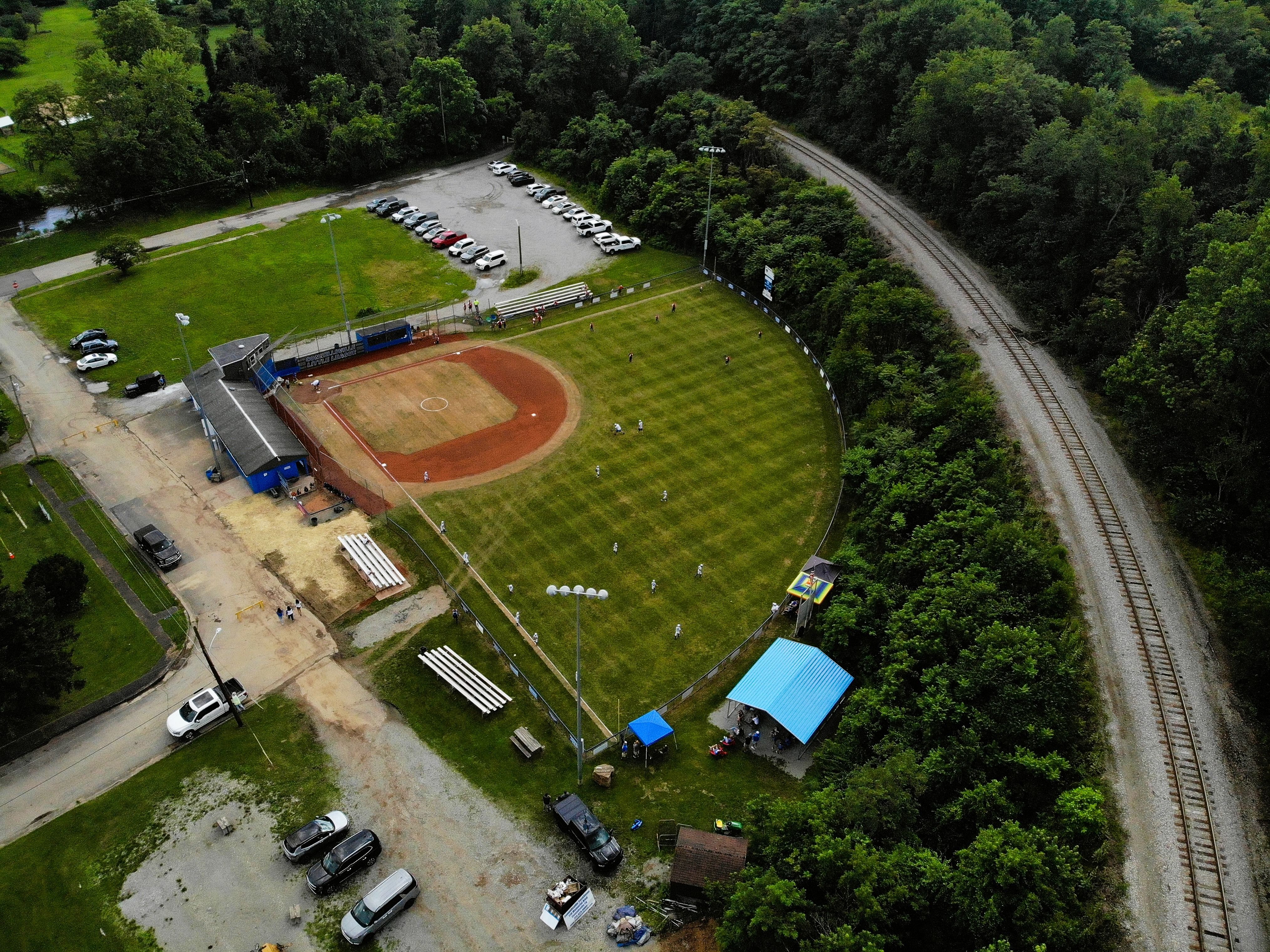 Aerial drone view of a little league baseball complex during a game